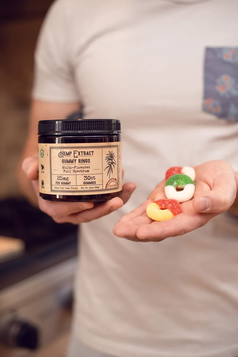 Hemp extract CBD gummy rings held in hand