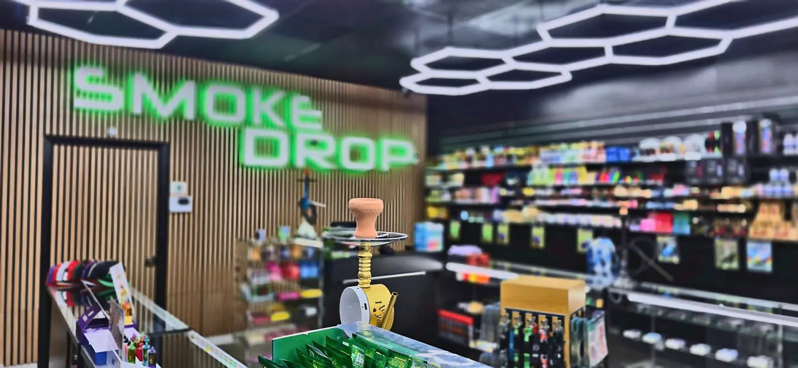 Interior of Smoke Drop's 24-hour Houston location with the lit Smoke Drop sign
