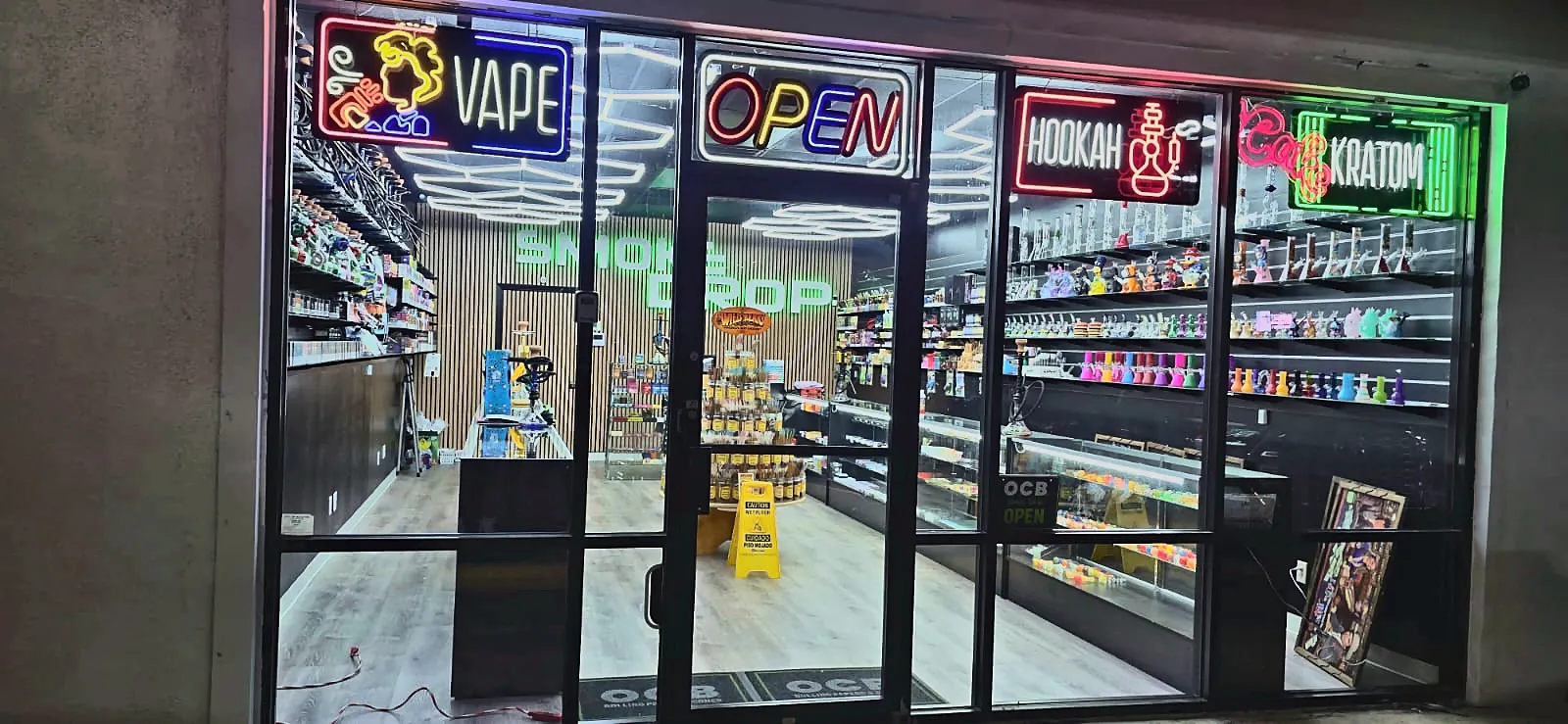 Smoke Drop 24-hour smoke shop at 8452 Gulf Fwy, Houston, lit up at night